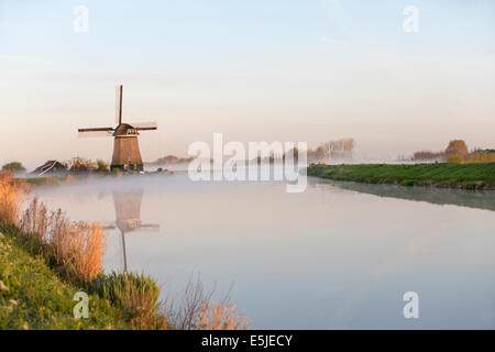 Netherlands, Wijdewormer, Windmill along belt canal of Beemster Polder, a UNESCO World Heritage site Stock Photo