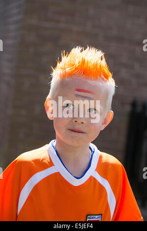 Netherlands, Marken, Child dressed in the national color orange on Kingsday, 27 April Stock Photo