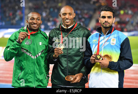 GLASGOW, SCOTLAND - AUGUST 02: Khotos Mokoena of South Africa with his gold medal in the mens triple jump with Tosin Oke of Nigeria (left, silver) and Arpinder Singh of India (right, bronze) during day 10 of the 20th Commonwealth Games at Hampden Park Athletics stadium on August 02, 2014 in Glasgow, Scotland. Credit:  Roger Sedres/Alamy Live News Stock Photo