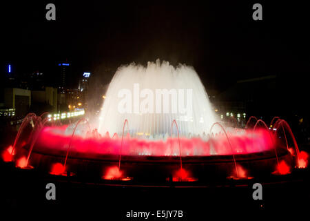 The Magic Fountain of Montjuic, situated below the Palau Nacional on the Montjuic hill and Barcelona by night Stock Photo