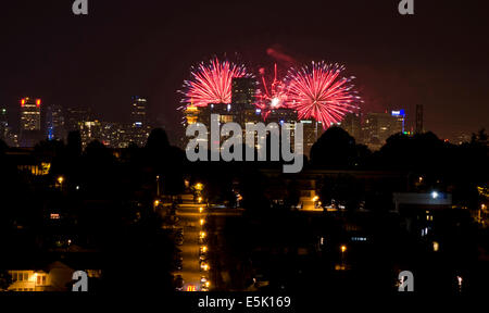 VANCOUVER, BC, CANADA. AUGUST 2, 2014: Downtown Vancouver is illuminated by the fireworks sent off from English Bay during the Honda Celebration of Light fireworks competition. Credit: Maria Janicki/Alamy Stock Photo
