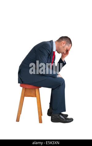 depressed businessman seated isolated on white background Stock Photo