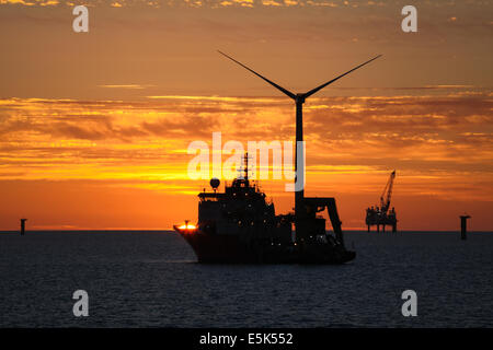 Sunset over the Gwynt y Mor Offshore Wind Farm off the coast of North Wales during the construction phase of spring 2014 Stock Photo