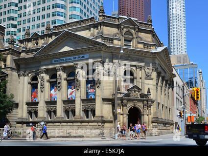 TORONTO - JUNE 27: Tourists stand outside the Hockey Hall of Fame on June 27, 2014. The Hall of Fame is the home of the Stanley Stock Photo