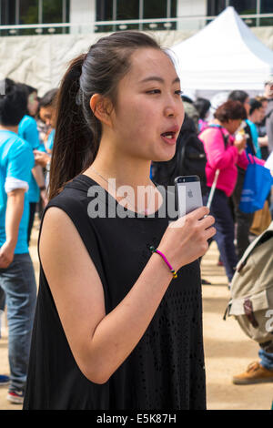 Melbourne Australia,Swanston Street,City Square,festival,Lord Mayor's Student Welcome,Asian woman female women,podcast,media,holding,iPhone,microphone Stock Photo