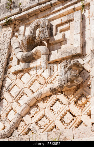 Snake Head and tail: Details from the facade in the Nunnery Quat. A long snake figures large in the detailed carved wall. Both t Stock Photo