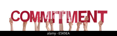 Many People Holding the Red Word Commitment, Isolated Stock Photo