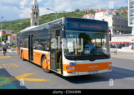 Bus coach driver at work front & side view of single decker public transport passenger bus stop street scene Port of Dubrovnik Gruz Dalmatia Croatia Stock Photo