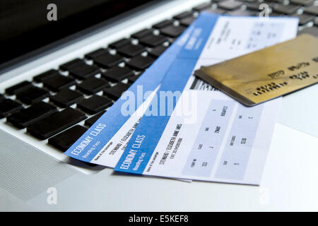 Buying airline tickets on line with a credit card Stock Photo