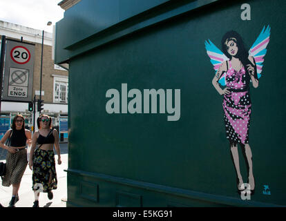 London, UK. 03rd Aug, 2014. London graffiti artist Pegasus has painted a new piece of the late singer Amy Winehouse. The work, which shows her wearing Union Jack angel's wings, has appeared on the side of antiques shop Paul's Emporium in North London not far from the singer's former home in Camden Town. American-born Pegasus has painted several portraits of her but says this new piece is his 'final farewell' to the singer who died just over three years ago. Credit:  Jeffrey Blackler/Alamy Live News Stock Photo