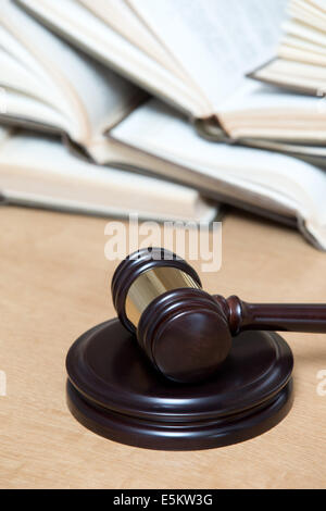 wooden gavel and books on wooden table Stock Photo