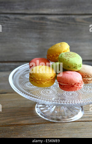 fresh macaroon on glass stand, food closeup Stock Photo