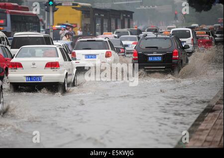 Taiyuan, China's Shanxi Province. 4th Aug, 2014. Cars drive on a waterlogged road in Taiyuan, capital of north China's Shanxi Province, Aug. 4, 2014. Heavy rainfall hit the city on Monday. Credit:  Fan Minda/Xinhua/Alamy Live News Stock Photo