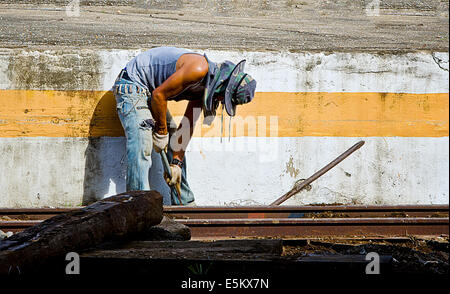 CHIANG MAI,THAILAND - AUGUST 2: Thai worker repairing railway at Chiang mai railway station on August 2,2014. Stock Photo