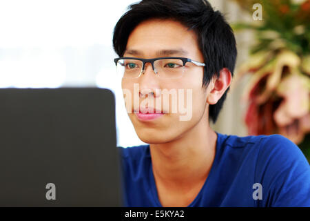 Serious asian man working on the laptop Stock Photo