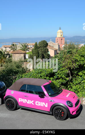 Pink Gin Advertising Car, Publicity Car or Pink Mini Cooper Convertible in front of View of Saint Tropez Old Town Var Côte d'Azur Provence france Stock Photo