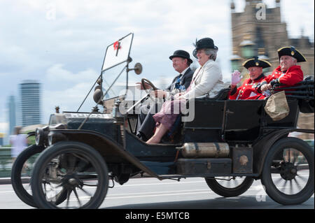 Westminster Bridge, London, UK. 4th August 2014. Chelsea Pensioners are driven over Westminster Bridge in Edwardian cars on their way to the Imperial War Museum in south London. The motorcade is part of the WW1 centenary marked by events all over Europe. Credit:  Lee Thomas/Alamy Live News Stock Photo