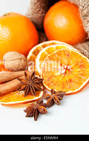 Christmas spices. Cinnamon sticks, anise stars, walnuts and sliced of dried orange Stock Photo
