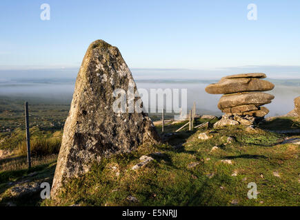 Granite Pinnacle and the Cheesewring on Stowe's Hill Illuminated by Early Morning Light and Surrounded by Mist Bodmin Moor Cornwa Stock Photo