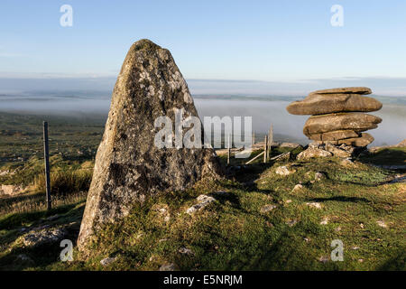 Pinnacle and the Cheesewring on Stowe's Hill Illuminated by Early Morning Light and Surrounded by Mist Bodmin Moor Cornwall Stock Photo