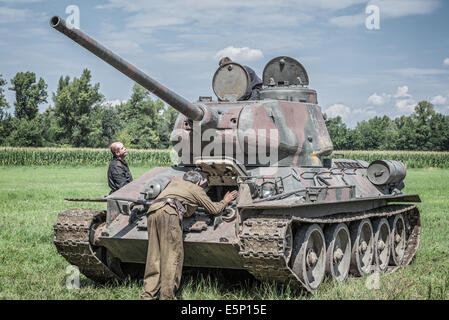 Russian soldiers checking a tank before attacking german positions during reenactment of World War II fights in Slovakia Stock Photo