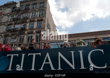 Tour bus with tourists sightseeing in New York City, NYC. Titanic advertising. New York City, New York, United States of America Stock Photo