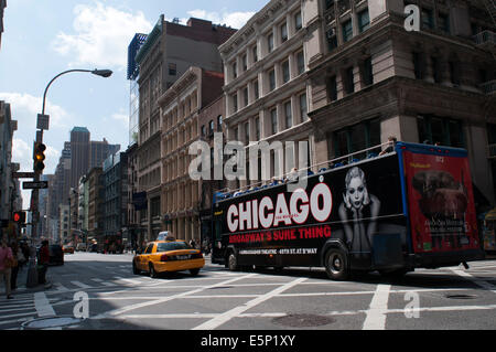 Tour bus with tourists sightseeing in New York City, NYC. Chicago the musical advertising. New York City, New York, United State Stock Photo