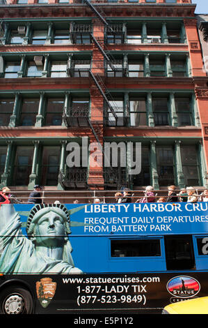 Fire Escape and Tour bus with tourists sightseeing in New York City, NYC. , Tribeca, Manhattan, New York City, New York. A fire Stock Photo