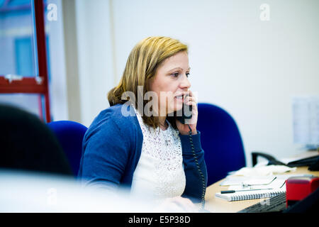 Office worker answering telephone call Stock Photo