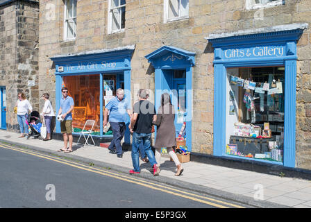 People walking past the Aln Gift Shop, Alnmouth, Northumberland, north east England, UK Stock Photo