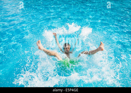 Man falling and splashing into water Stock Photo