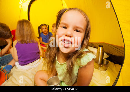 Six funny kids are sitting in a tent Stock Photo