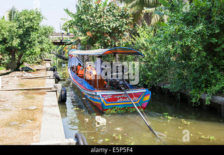 A Long-Tail Boat cruising through Bangkok's Klongs, Bangkok, Thailand Stock Photo