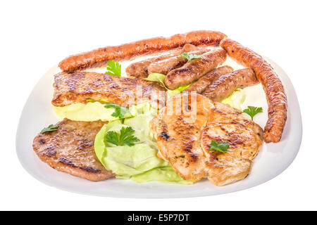 barbecue of various grilled meat on white plate closeup; barbecue with sausages, chicken and beaf steak with vegetables Stock Photo