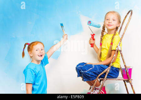 Two girls with brushes Stock Photo