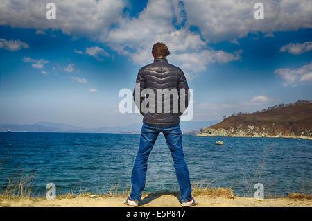 Portrait young  man in suit face to the sea Stock Photo