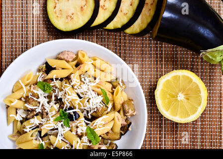 Pasta with eggplant, tuna, mint and ricotta salata. Recipe of Italian cuisine Stock Photo