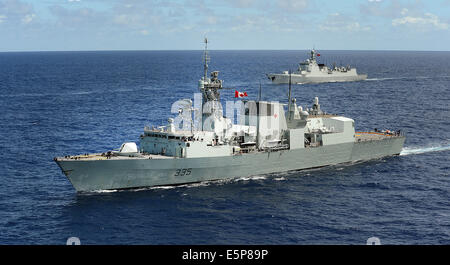 The Royal Canadian Navy Halifax-class frigate HMCS Calgary, foreground, and the People's Liberation Army Navy Luyang II class destroyer Haikou during Rim of the Pacific Exercise July 25, 2014 off the coast of Hawaii. Stock Photo