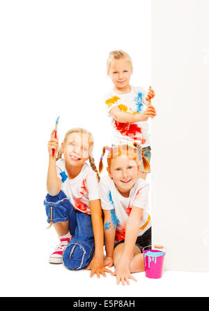 Three little girls in painted shirts smile Stock Photo