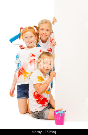 Three nice girls pose near wall Stock Photo