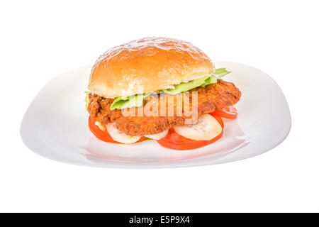 veal burger in bread bun with cucumber and tomato isolated on white plate; fried veal schnitzel burger Stock Photo