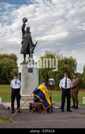 UK, London, Twickenham, Radnor Gardens, 4th August, 2014. A vigil to commemorate the declaration of war was held. Police Officers flank the War Memorial, the Eternal Flame and the Standard of the Royal British legion.  The public were invited to a sunset Commemorative service conducted by Father David Loftus MBE. Credit:  Eden Breitz/Alamy Live News Stock Photo