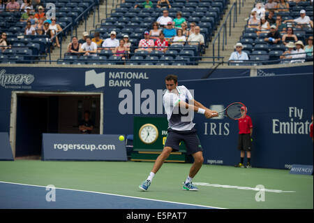 Toronto, Canada. 4th Aug, 2014. Marin Cilic of Croatia returns a shot to Denis Istomin of Uzbekistan during the Rogers Cup at the Rexall Centre on August 4, 2014 in Toronto, Ontario, Canada. Credit:  Julian Avram/Alamy Live News Stock Photo