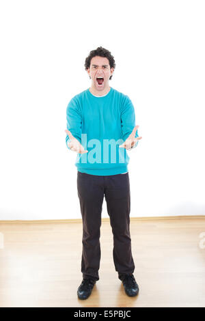 Nervous man in stress with cramped hands yelling, Young casual business man with frustration expressing crisis under pressure Stock Photo