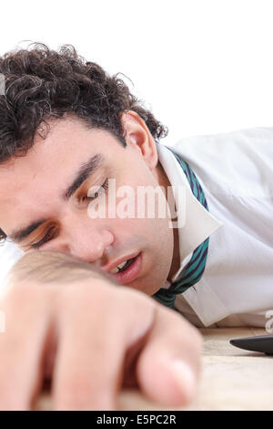 photo of exhausted, sleeping and overworked business man  with laptop beside him on office desk at his work Stock Photo