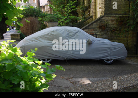 Porsche under cover parked in front of Hampstead home, London UK Stock Photo