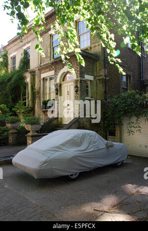 Porsche under cover parked in front of Hampstead home, London UK Stock Photo