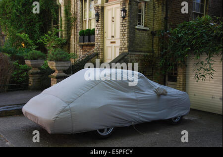 Porsche under cover parked in front of Hampstead home, London UK Stock Photo