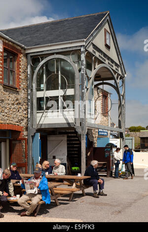 UK England, Dorset, Charmouth, Fine Foundation Heritage Coast Centre, visitors sat in sun Stock Photo