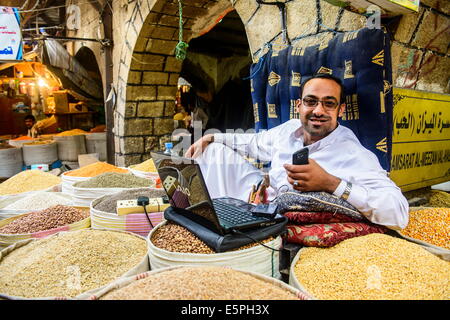 Shopkeeper at the spice market in the Old Town, UNESCO World Heritage Site, Sanaa, Yemen, Middle East Stock Photo